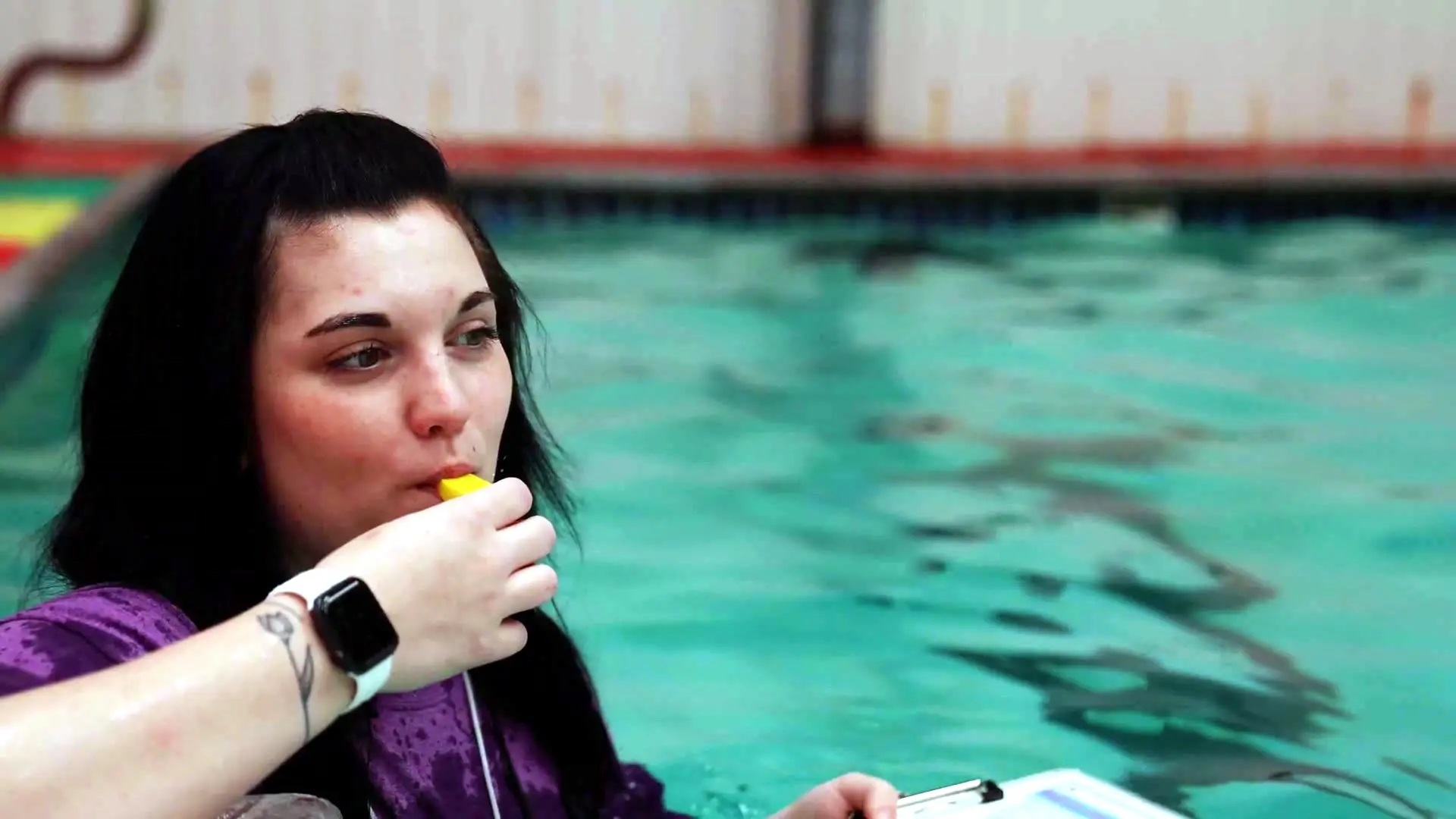 A Swimsational coach leads swimmers during team practice